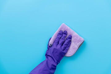 Hand clean with rag on blue background