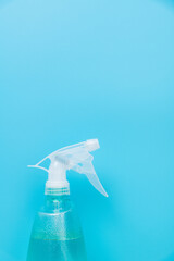 Plastic spray bottle on blue background