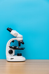 Close up of microscope on wooden table