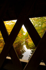 Fototapeta na wymiar Inside Keniston Covered Bridge in New Hampshire, with fall colors.