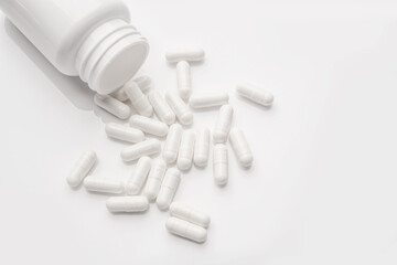 Pill capsule on white background, health care concept.