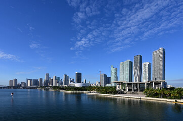 City of Miami, Florida reflected in calm water of Biscayne Bay on sunny autumn morning.