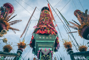 Salak yom at Wat Phra That Hariphunchai in Lamphun. The tradition of making merit, the tall dyed lott trees are decorated with different colored paper and clothing items to pay homage to the souls.