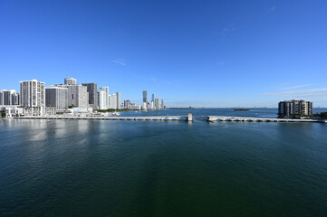 Fototapeta na wymiar Residential waterfront buildings on Biscayne Bay in Miami, Florida on clear calm sunny autumn morning..