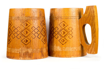 Two old wooden mugs with ornaments.