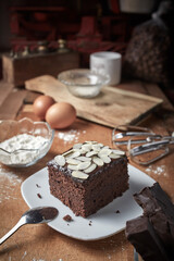 a piece of steamed brownies cake or brownies kukus with almond topping delicious cake