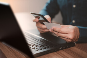 Man using credit card for purchasing and shopping online on mobile phone. Mobile payment with wallet app technology. Digital money transfer, banking and e commerce concept.
