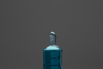 Medical syringe showing liquid bubbling and dripping has its expelled under pressure from syringe