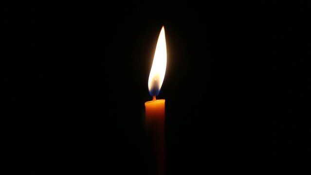 burning candle light up in the dark.