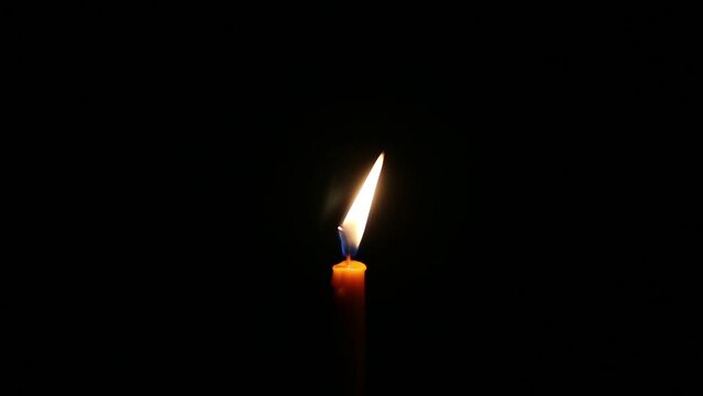 burning candle light up in the dark.