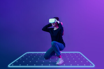 Asian woman wearing VR headset with new experience  playing video game and light mark zone area for...