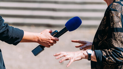 News reporters interviewing an important person outdoors