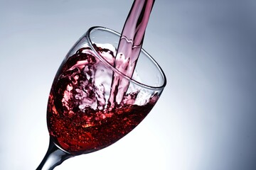 image pouring red wine into a glass
