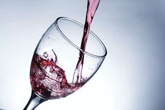 image pouring red wine into a glass