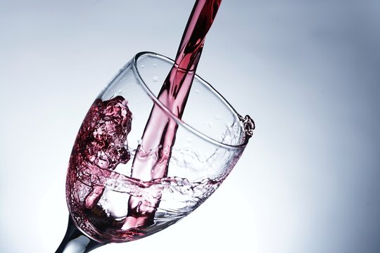 image pouring red wine into a glass