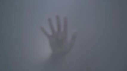 Blurred footage, fogged glass in the shower where the hand appears - Powered by Adobe