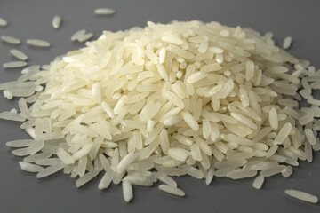 Close up of grains of white rice against a grey background