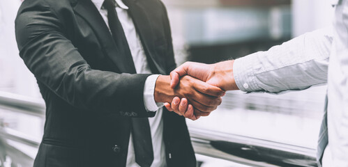 Two businessman shaking hands, business deals and congratulations on success concept. 