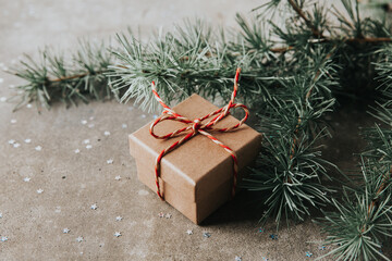 Gift box and Christmas tree branches. Celebration of Christmas and New Year.