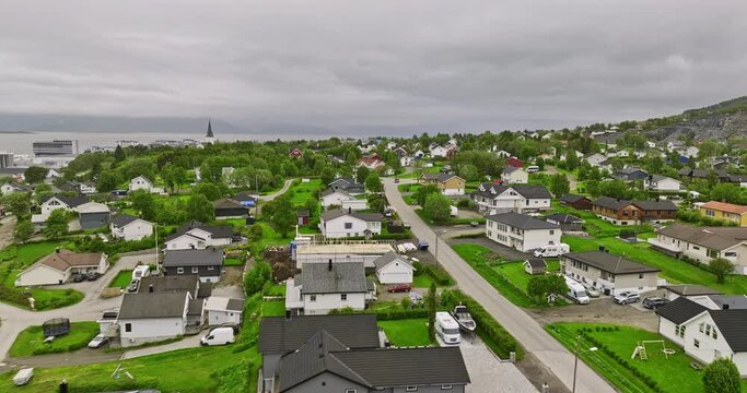 Sortland Norway v1 low flyover residential neighborhood with scandinavian norwegian houses, towards blue town with view of strand across sortlandsundet strait - Shot with Mavic 3 Cine - June 2022