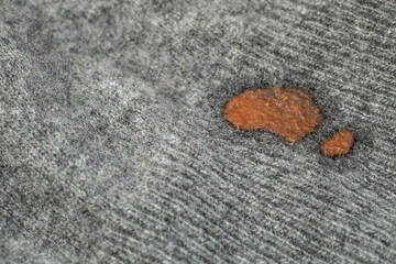 Dried red tomato stain on cashmere fabric