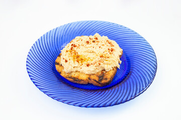 Humus paste with paprika powder on a toasted slice of bread