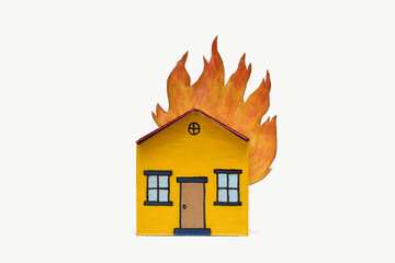 Yellow red toy cardboard house roof on fire middle of frame isolated white background