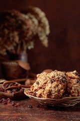 Oatmeal raisin cookies on a brown table.