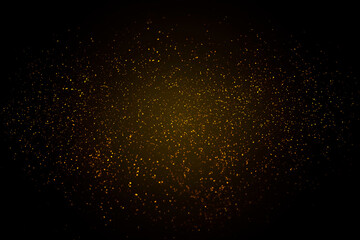 Fototapeta na wymiar yellow particles on a black background. glitter