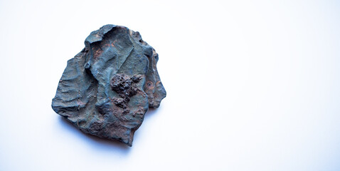 A piece of iron ore on a white isolate. Iron ore on a white background, a clean place for text.