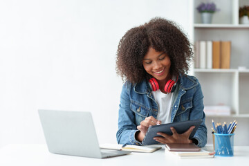 Female student wearing headphones study idea to deliver a video call teacher report on laptop smiling face and a happy studying expression.