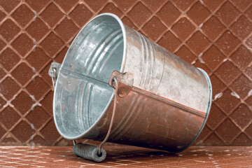 Metal bucket on the reverse side of the ceramic tile