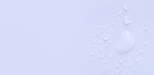 water drops of transparent gel serum on a pastel background