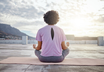 Yoga, back view and woman in meditation on roof training to meditate body and spiritual mind in Cape Town city. Fitness, wellness and zen girl in peaceful lotus pose for a relaxing exercise outdoors