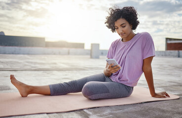 Fototapeta na wymiar Phone, yoga and woman browsing on social media while sitting on a mat on workout break outdoor. Fitness, communication and girl athlete networking on the internet with smartphone while doing exercise