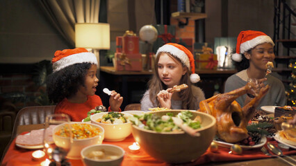 A group of multi ethnic.Portrait of Caucasian and African American black family have a celebration dinner in party with wine, champagne on Merry Christmas Eve Xmas on holiday at home. People lifestyle