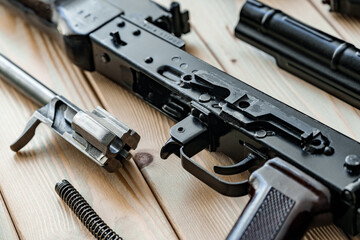 Shotgun parts on the wooden table background.