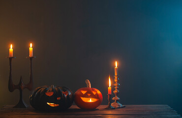 halloween pumpkins with burning candles on dark background
