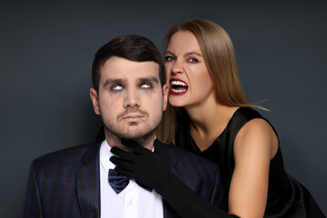 Concept of Halloween, young man and woman on dark background