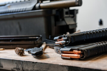 Fototapeta na wymiar Shotgun rifle with cartridges on table in a weapon workshop