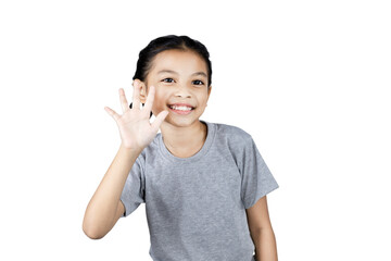 Close up Asian little girl smiling happy positive attractive waving hand greeting say hi hello with clipping path. studio portrait.