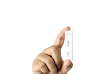 Own hand showing Covid-19 positive test result with SARS CoV-2 Rapid antigen test kit (ATK) with clipping path. with copy space, Coronavirus infectious protective concept.