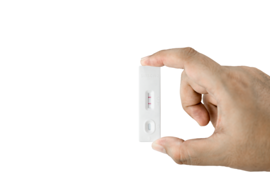 Own hand showing Covid-19 positive test result with SARS CoV-2 Rapid antigen test kit (ATK) with clipping path. with copy space, Coronavirus infectious protective concept.