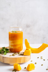 Pumpkin smoothie. A healthy vegan breakfast drink with pumpkin pieces and seeds.