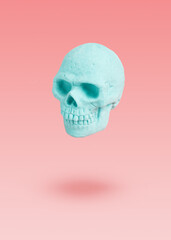 Mint skull levitation on a purple background. pastel concept