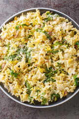 Sicilian Mafalda Corta Pasta di Gragnano with Lemon, Roasted Pistachios and Wild Rocket closeup in the plate on the table. Vertical top view from above