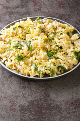 Mafalda Pasta with arugula, pistachios, parmesan cheese and lemon zest close-up on a plate on the table. Vertical