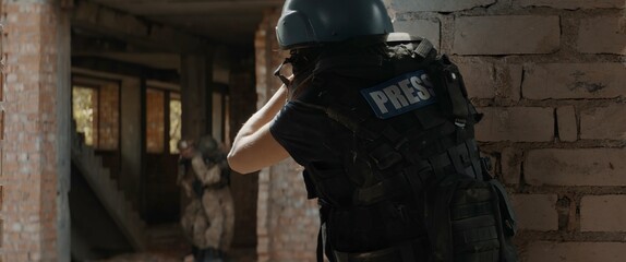Caucasian female war journalist wearing protective helmet and bulletproof vest gear taking photos...