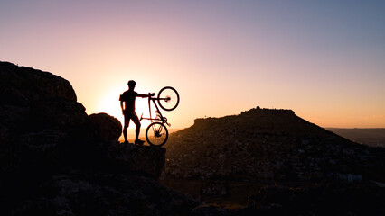 lifestyle and summit success of crazy athlete cycling in the mountains