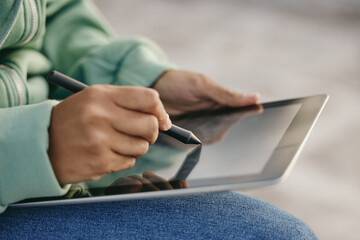 Hands, tablet and design with a woman on the internet with a stylus for creative work outside...
